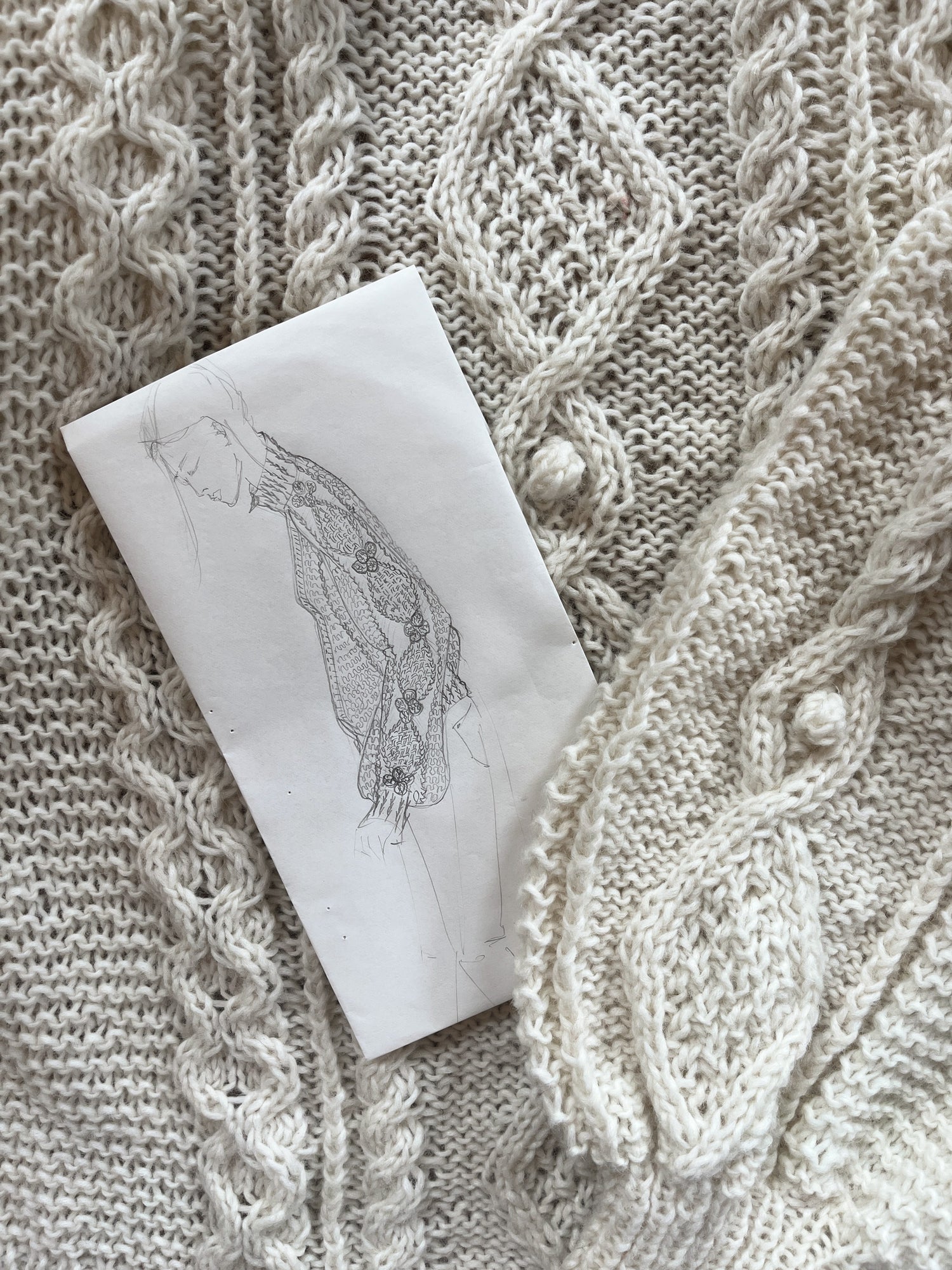 Naturally luxurious hand knit cream cable sweater and detailed designer sketch by BAWN